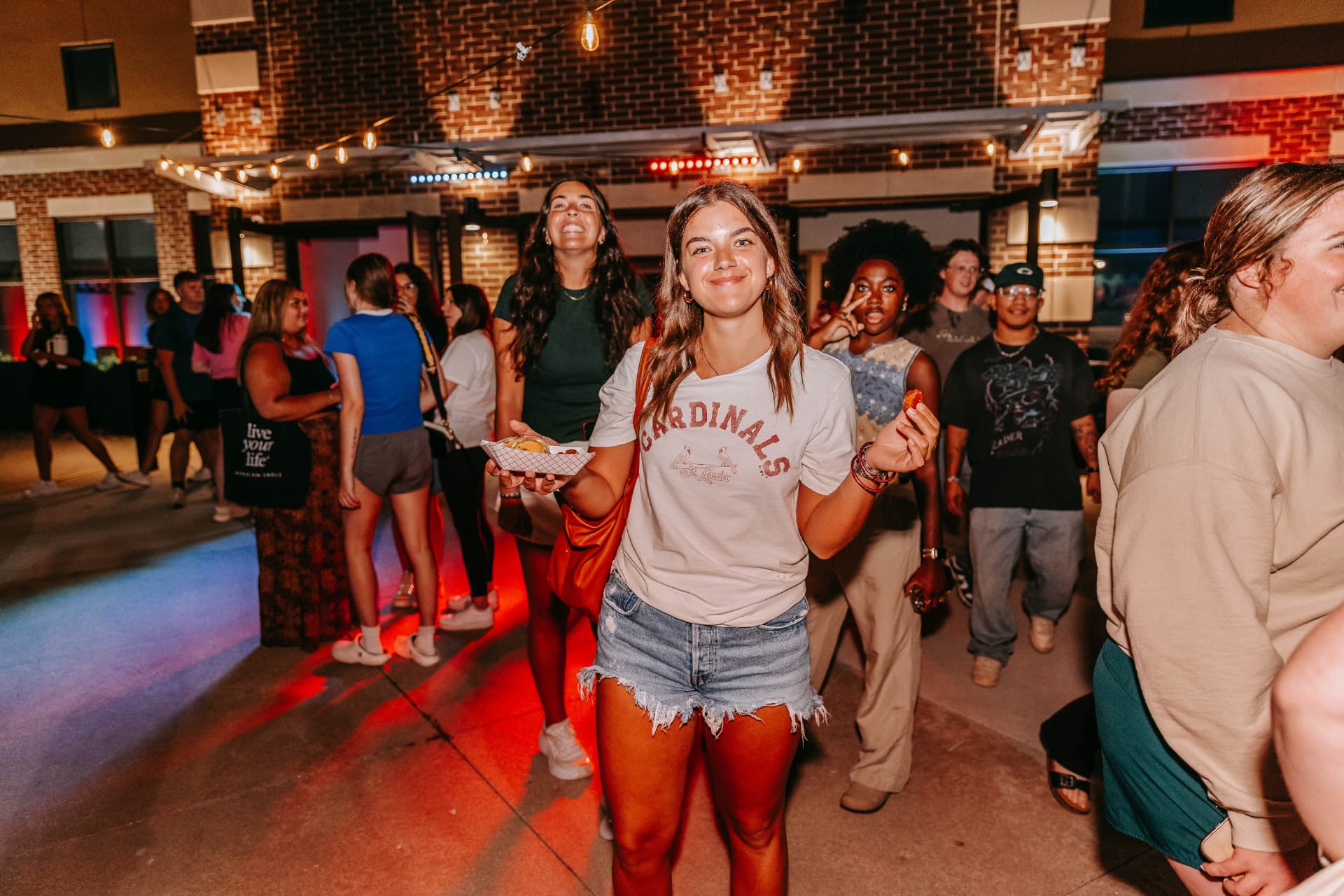 A guest grabbing a pretzel bite at a night event