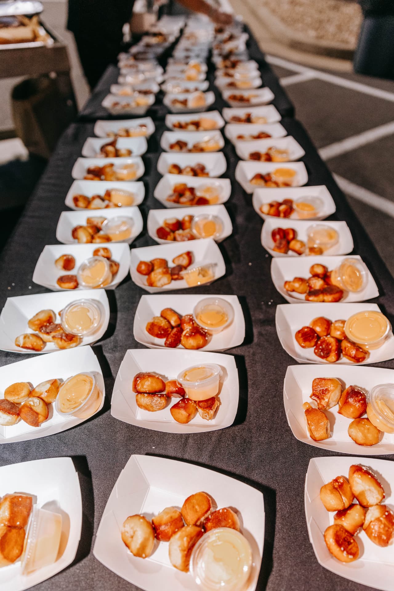 A long table lined with pretzel trays for a big event