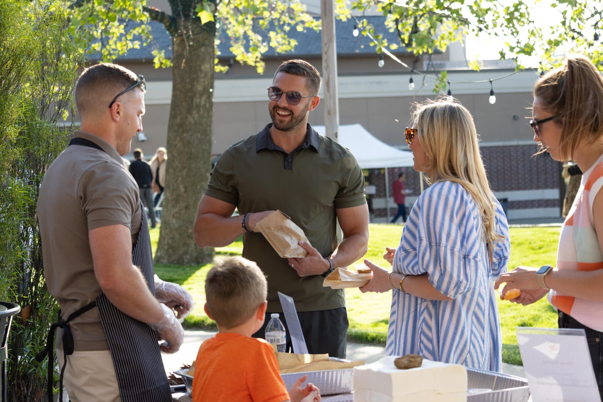 Nathan serving pretzels to guests at an outdoor event